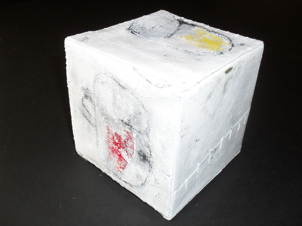 Cube encased in stiff paper with painted beakers DUNIH 2011.1.63