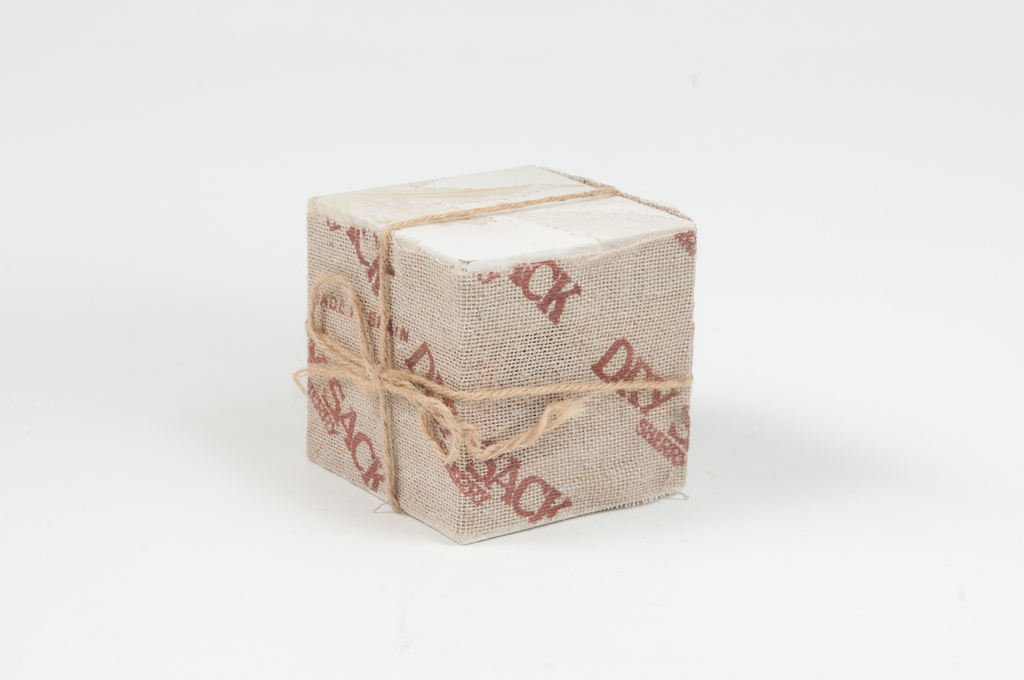 Cube covered in \"Dry Sack Sherry\" paper DUNIH 2011.1.69