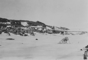 Image of Cape Dennison, Mawson's hut and plane. DUNIH 1.355