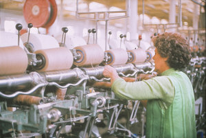 Image of Woman operating a cop winding frame DUNIH 2006.1.44.2