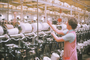 Image of Woman operating a cop winding machine DUNIH 2006.1.44.26
