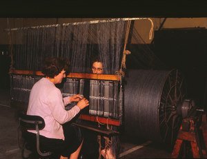 Image of Two women working with a beam DUNIH 2006.1.75.28