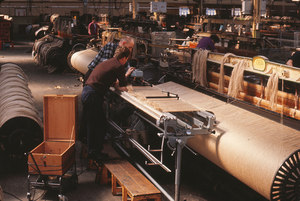 Image of Two men fixing a new beam into a loom DUNIH 2006.1.75.29