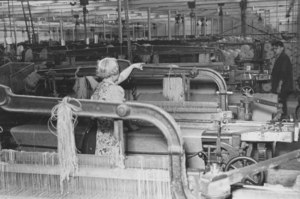 Image of Buist Factory- weaver at loom DUNIH 2007.59.1
