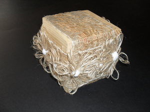 Image of Cube with jute scrim and jute twine "flowers". DUNIH 2011.1.22