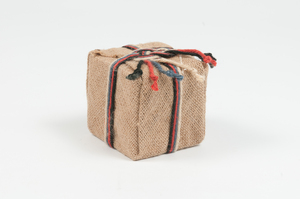 Image of Cube wrapped in jute as parcel, tied with jute twine. DUNIH 2011.1.24