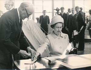 Image of Photograph of the Queen signing an image of herself, May 1969 DUNIH 2017.16.2.33
