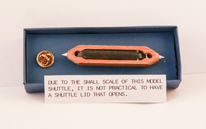 Image of Model Shuttle Lapel Pin worn by members of the Weavers Craft DUNIH 2014.12.25