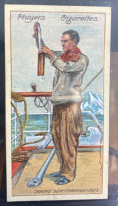 Image of CIGARETTE CARD, Second Series no.5 Staff-Paymaster Francis Drake, Secretary and Ship's Meteorlogist, Taking Sea temperatures, one of a collection of cigarette cards detailing Polar Exploration DUNIH 2022.18.30